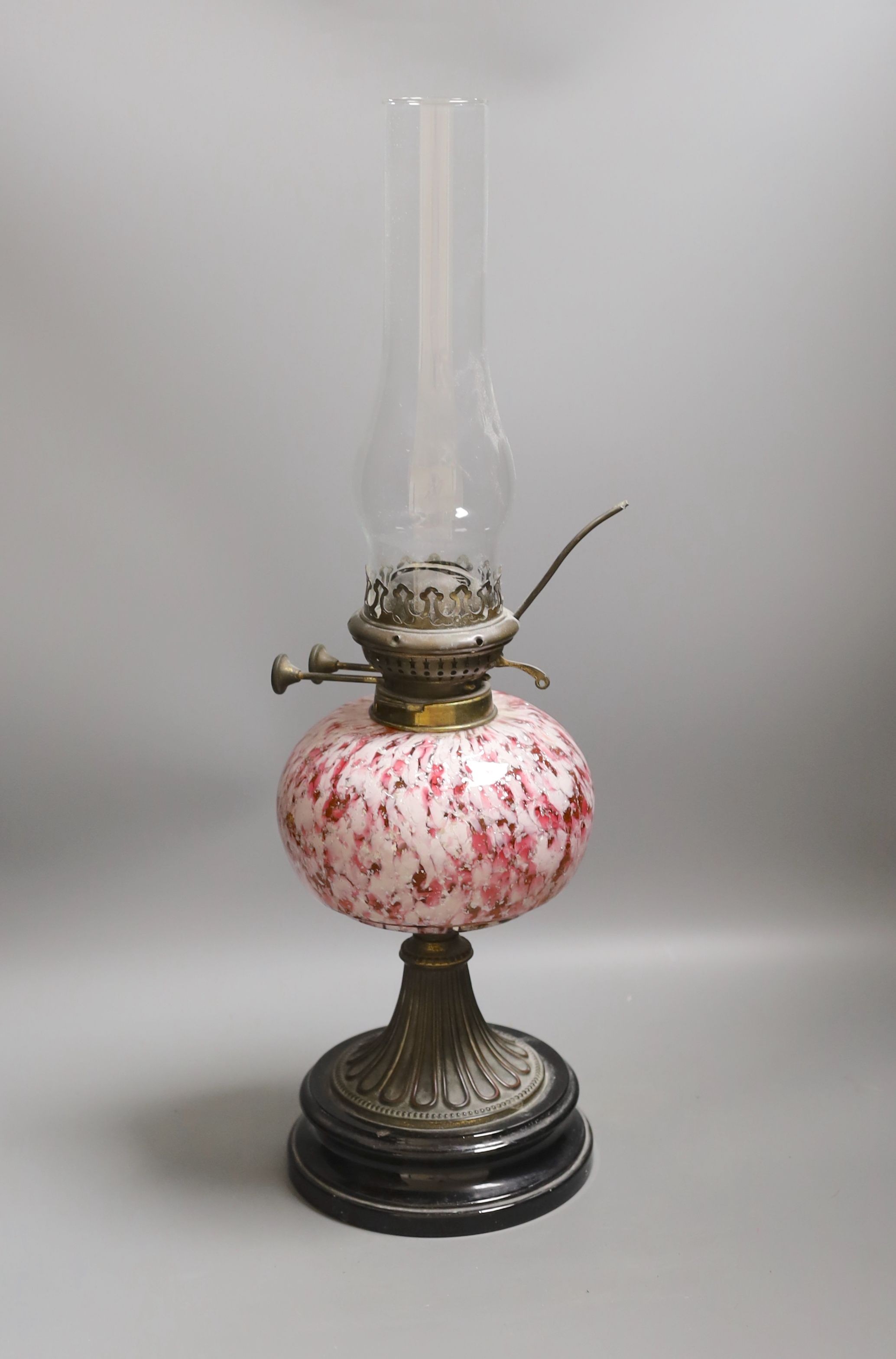 A 19th century mottled glass oil lamp, 55cm total height